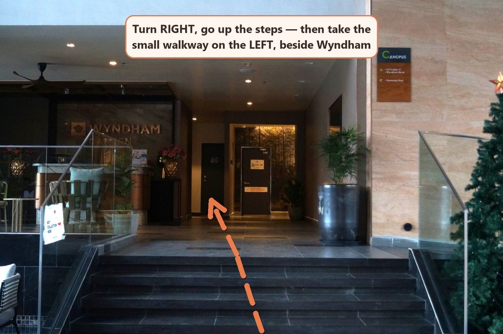Lobby steps with the small walkway on the left beside Wyndham