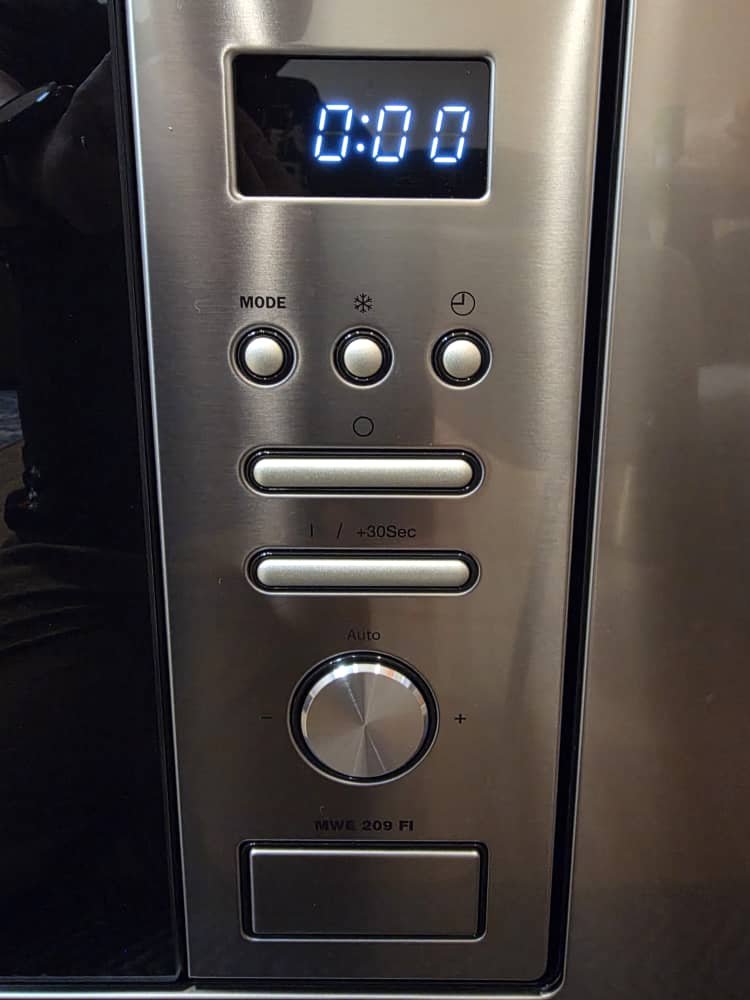 Microwave oven control panel — mode button, dial, and display